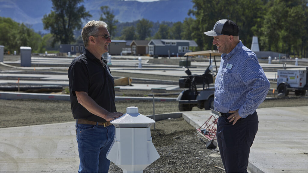 Banker and client speak on construction site at Bar Run Golf.