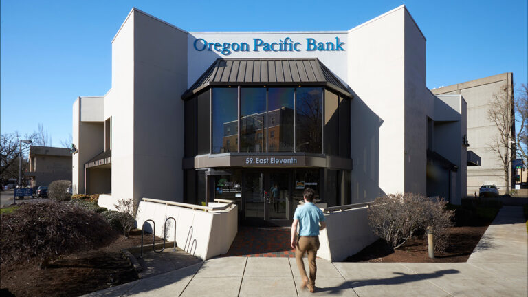 Visitor walking in to Oregon Pacific Bank's Eugene Branch.