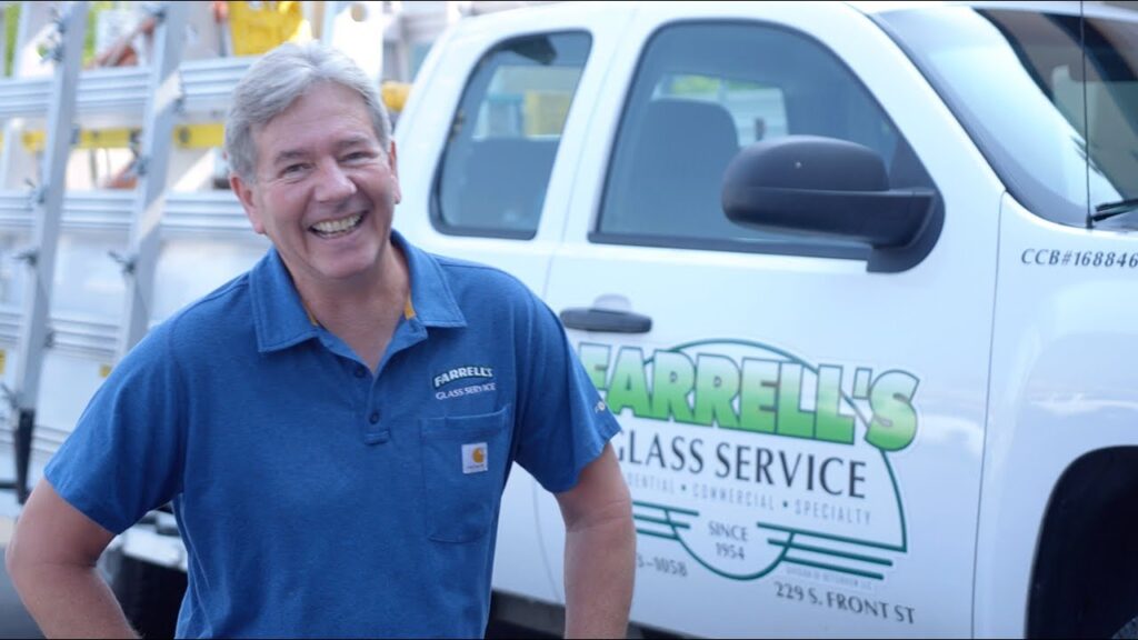 Owner of Farrell Glass standing outside by his truck.