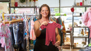 Nonprofit owner posing in her shop.