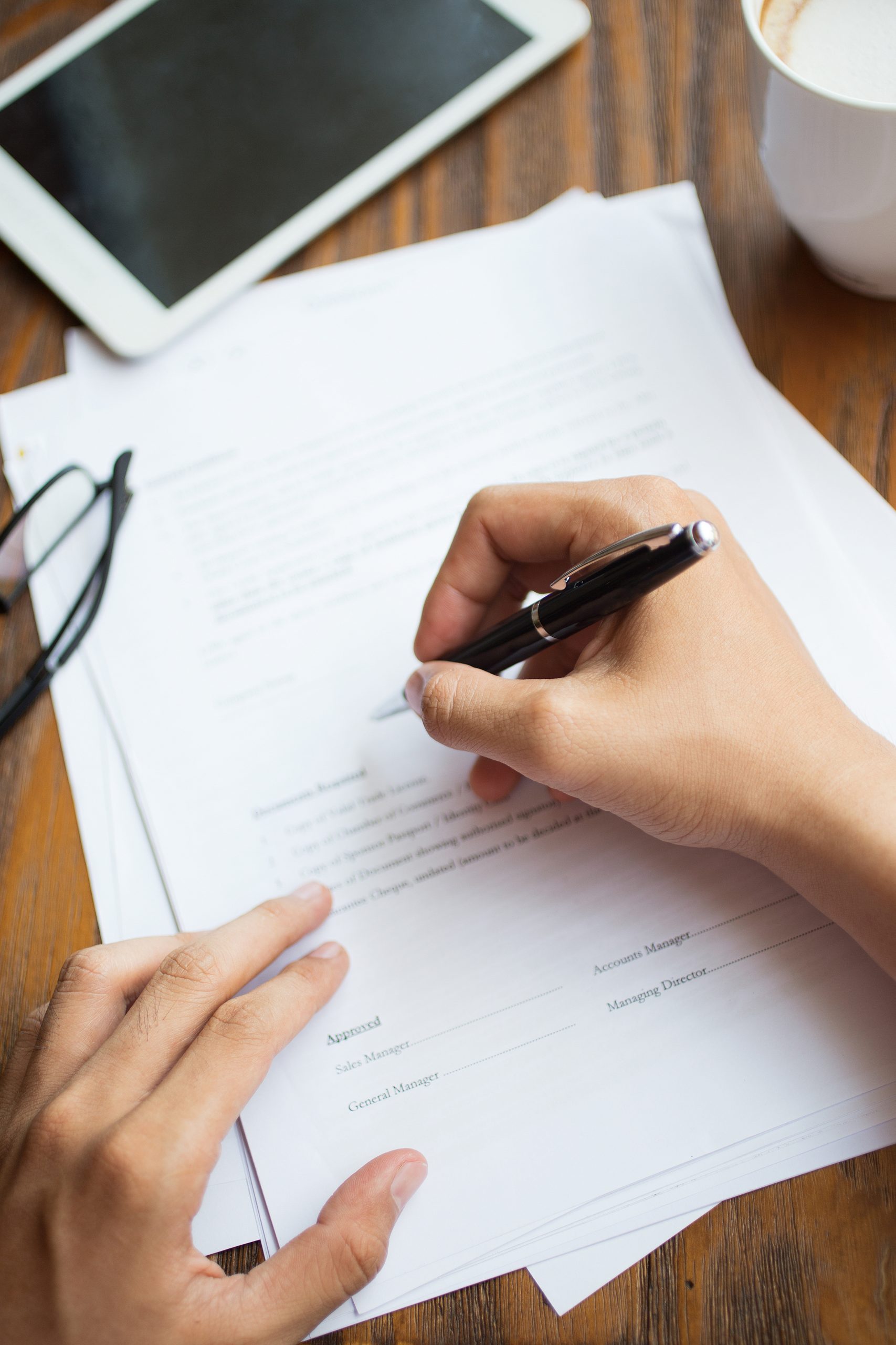 Unrecognizable man filling application form. Businessman checking papers. He signing document. Manager working with report. Financial report concept